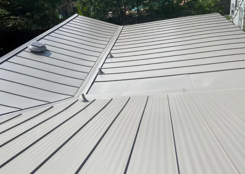 Solar attic fan installed on a metal roof for Roof Ventilation in Polk